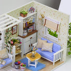 Blue gingham miniature sofa and white display cabinet set against floral wallpaper in a handmade cottage living room craft kit