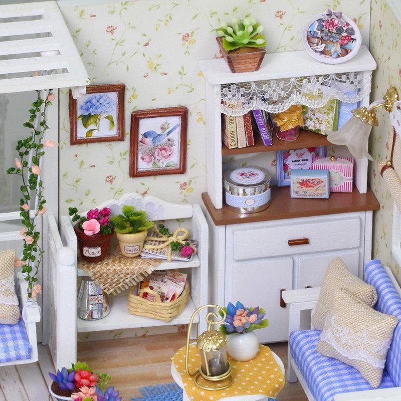 Miniature display hutch filled with tiny books, tins and potted flowers, a detailed cottage room kit for miniature crafters