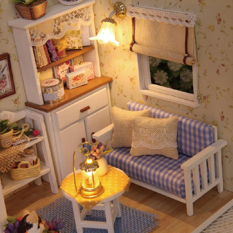 Warm LED lamps lighting a miniature cottage room with a music box and gingham sofa, a relaxing craft gift for adults and teens