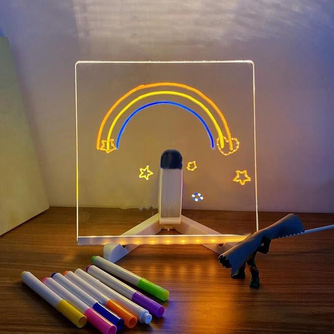 Glowing acrylic doodle board kit with seven colored markers drawing a bright rainbow, a fun screen-free toy for kids