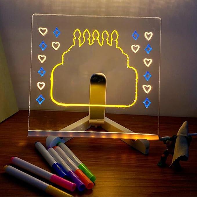 Erasable glow drawing board doubling as a soft bedroom night light with a warm birthday cake doodle for kids