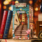 Illuminated book nook shelf insert with glowing street lamps and lit shopfronts creating a warm miniature city scene