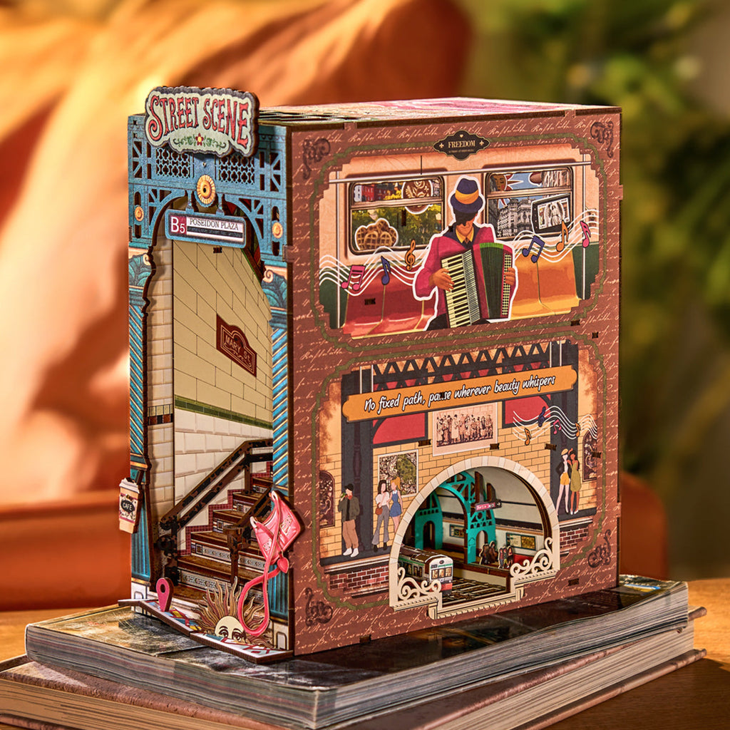 Miniature city diorama book nook with textured pavements and tiny storefronts for a detailed lit bookshelf display