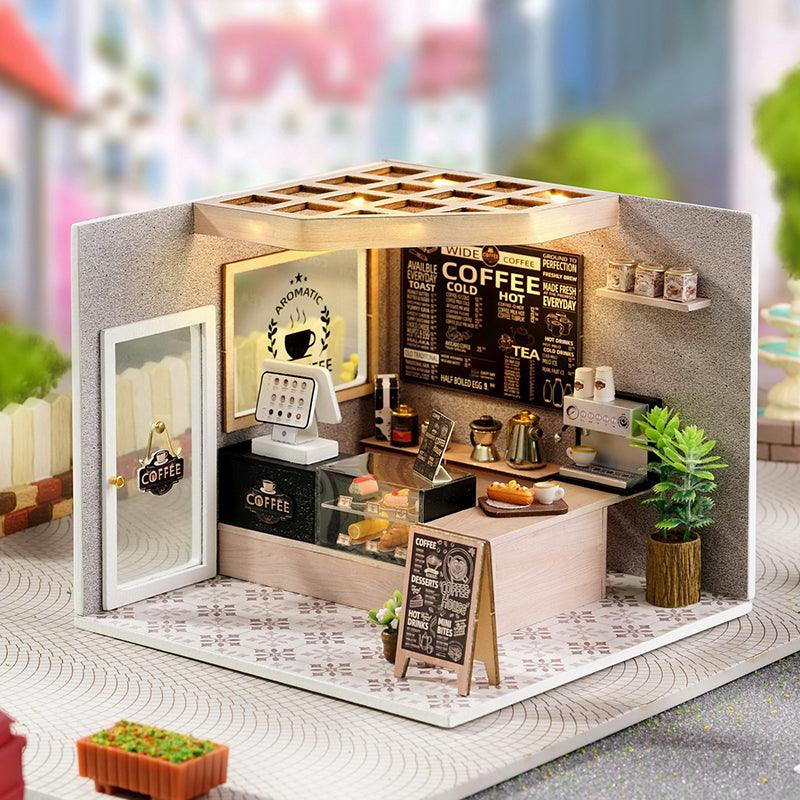 Miniature coffee shop dollhouse kit with barista counter, dessert case and a lit menu board for coffee lovers to build and display