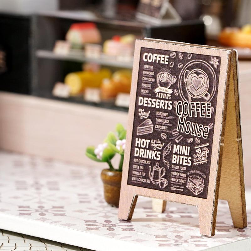 Miniature cafe chalkboard menu sign with drinks and dessert artwork, a charming accent piece for a handmade coffee shop model