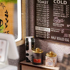 Detailed cafe menu board with tea tins and pantry props at 1:24 scale, a realistic feature of this build it yourself coffee shop