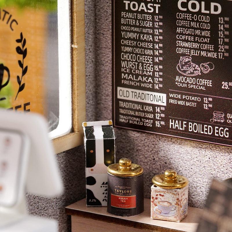 Detailed cafe menu board with tea tins and pantry props at 1:24 scale, a realistic feature of this build it yourself coffee shop