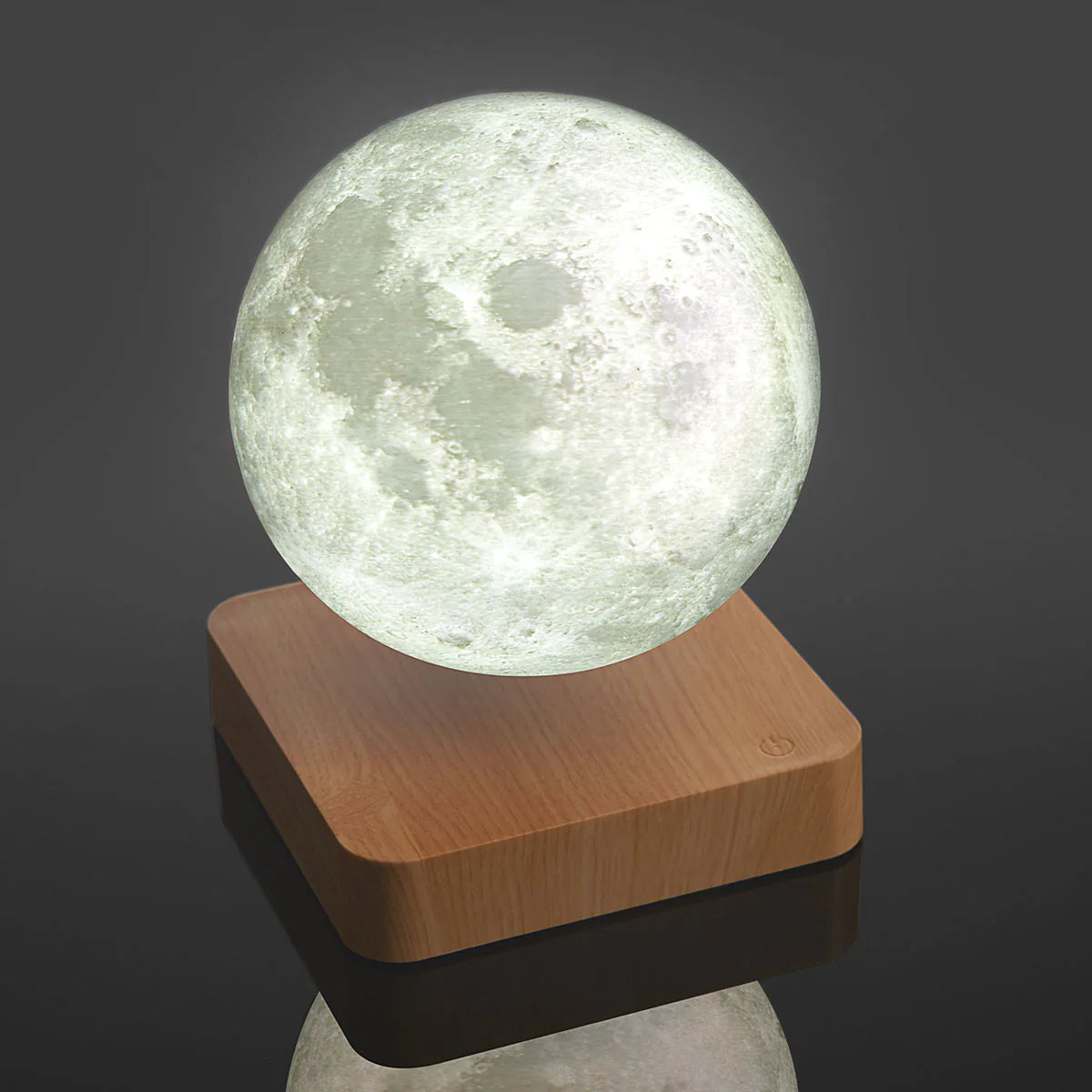 Levitating moon lamp with magnetic floating globe glowing cool white above a solid wooden base for bedroom decor