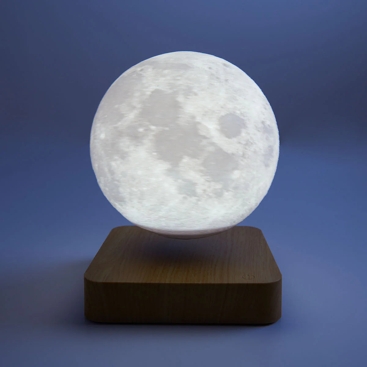 Magnetic floating moon night light with a 3D printed lunar globe hovering over a wooden base for restful bedrooms
