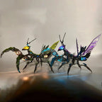 Poseable metal praying mantis desk sculpture with glowing LED eyes for a gaming room shelf accent, available in Green and Purple