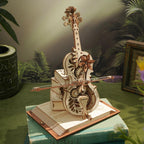 Vintage cello music box on a stacked book base, a laser cut wooden puzzle and shelf decor gift for cellists and musicians