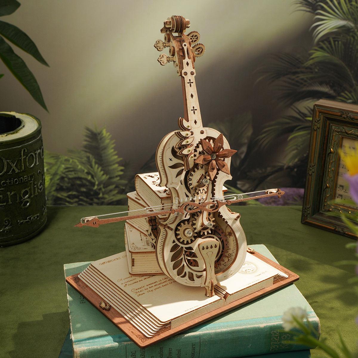 Vintage cello music box on a stacked book base, a laser cut wooden puzzle and shelf decor gift for cellists and musicians
