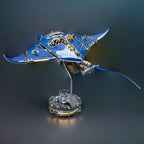 Manta ray metal desk sculpture with kinetic wings and soft LED glow for an ocean themed office accent