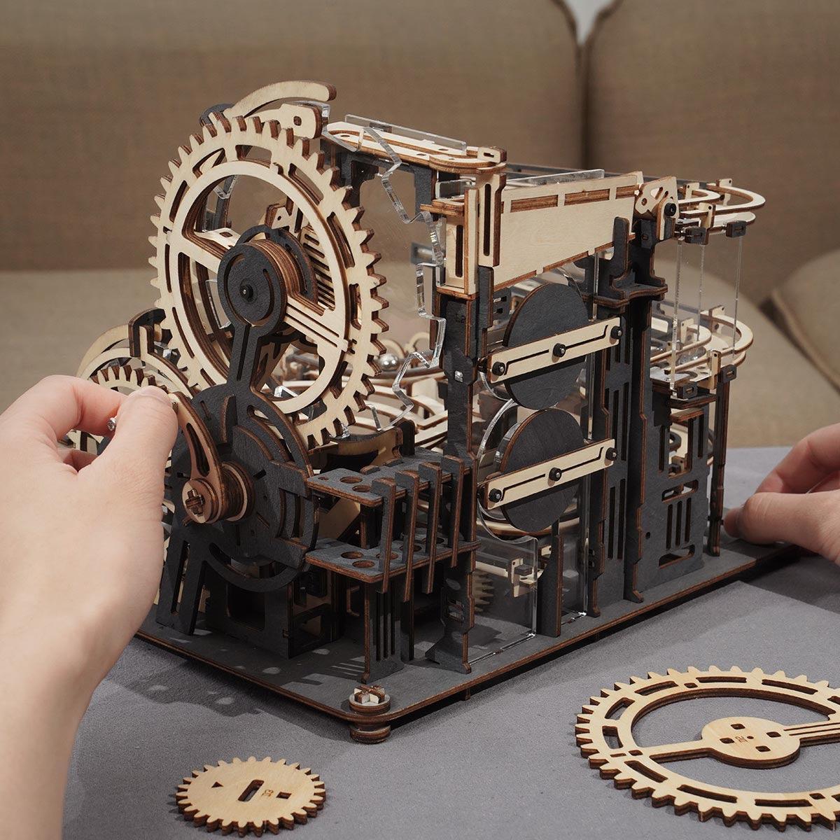 Hand crank wooden marble run driving marbles through gears and lifts, a kinetic engineering build and STEM gift