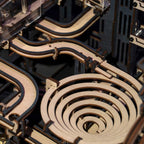 Spiral descent funnel on a laser-cut wooden marble run, a kinetic mechanical model and desk decor for engineers