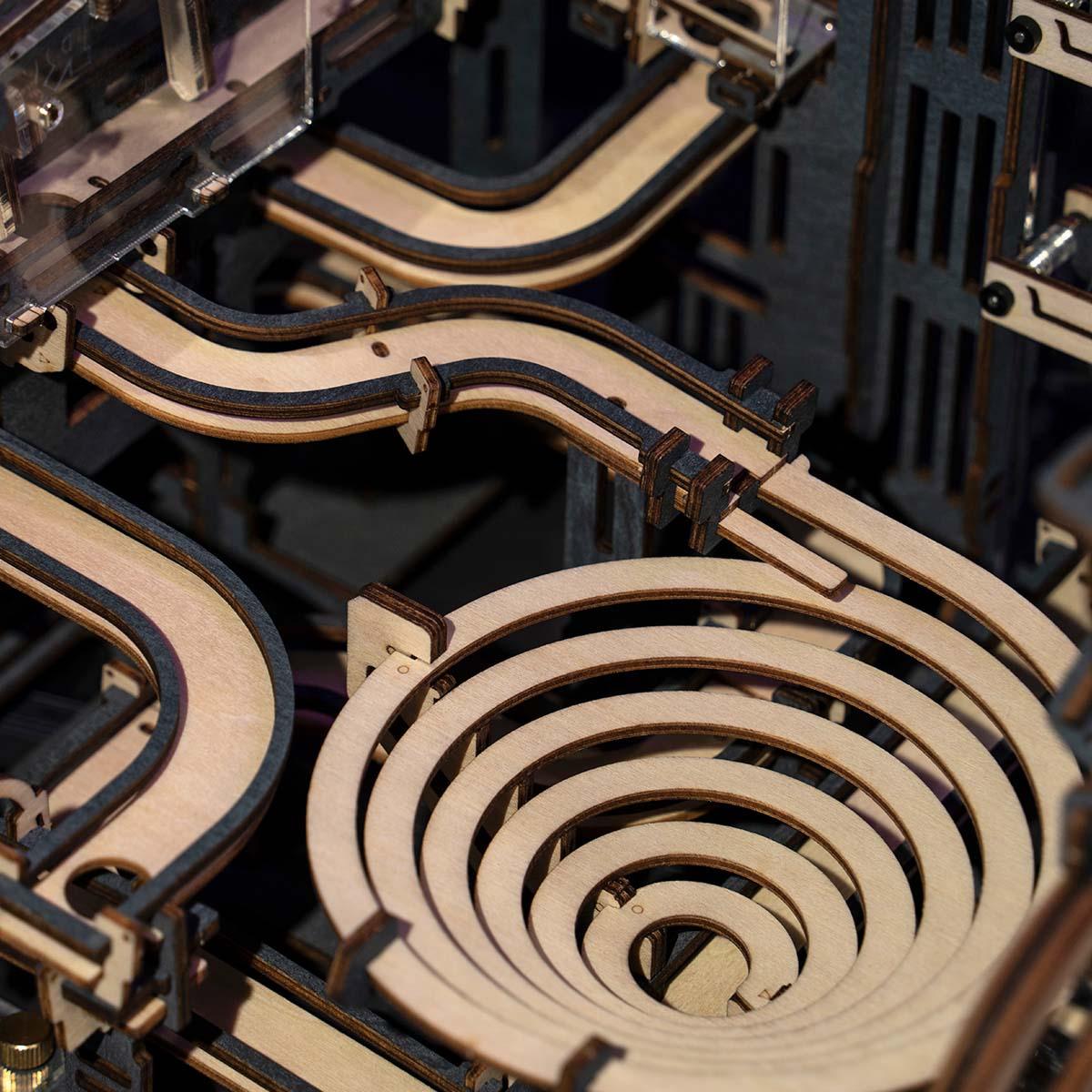 Spiral descent funnel on a laser-cut wooden marble run, a kinetic mechanical model and desk decor for engineers