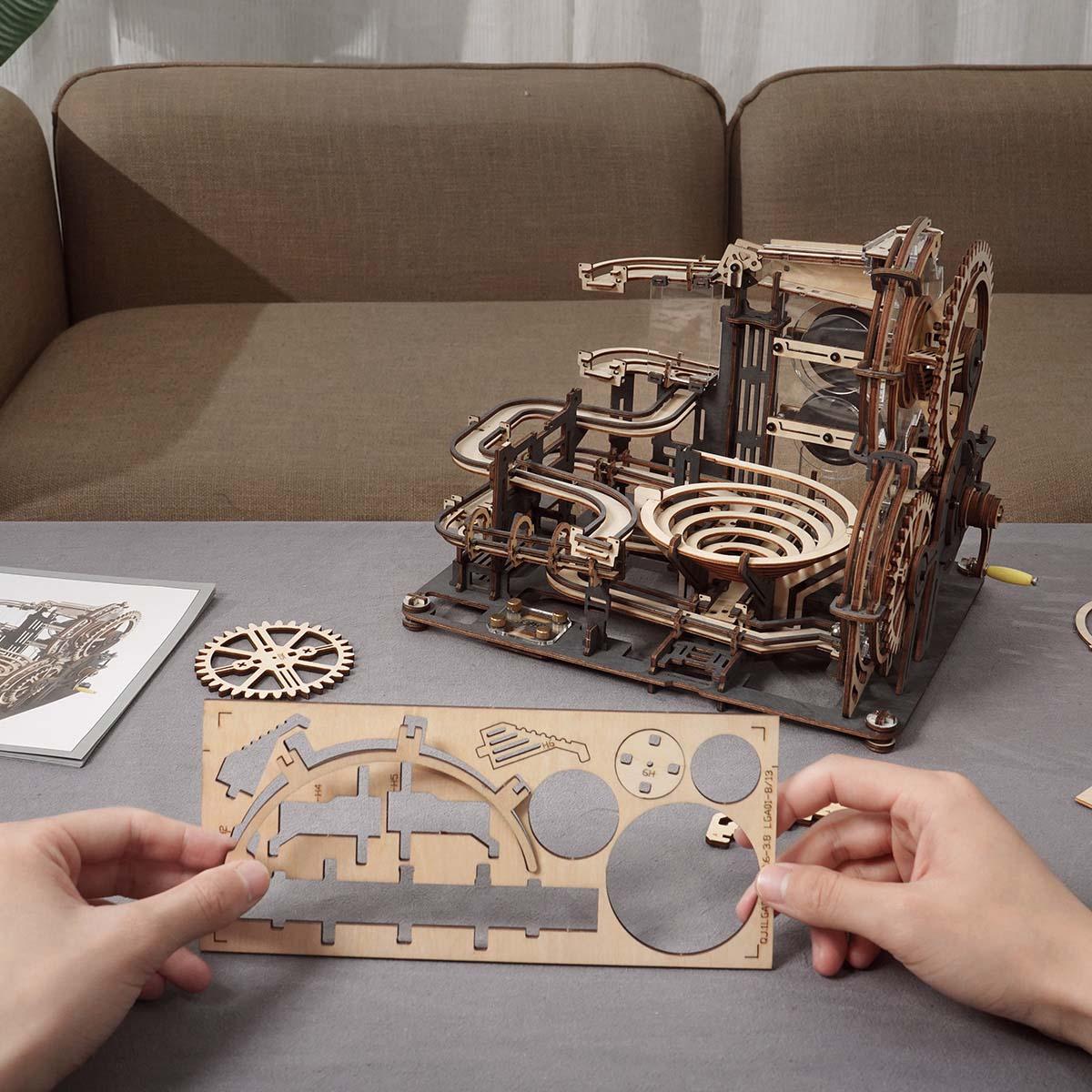 Building a wooden marble run from laser-cut pieces at home, a screen-free STEM model kit and gift for families