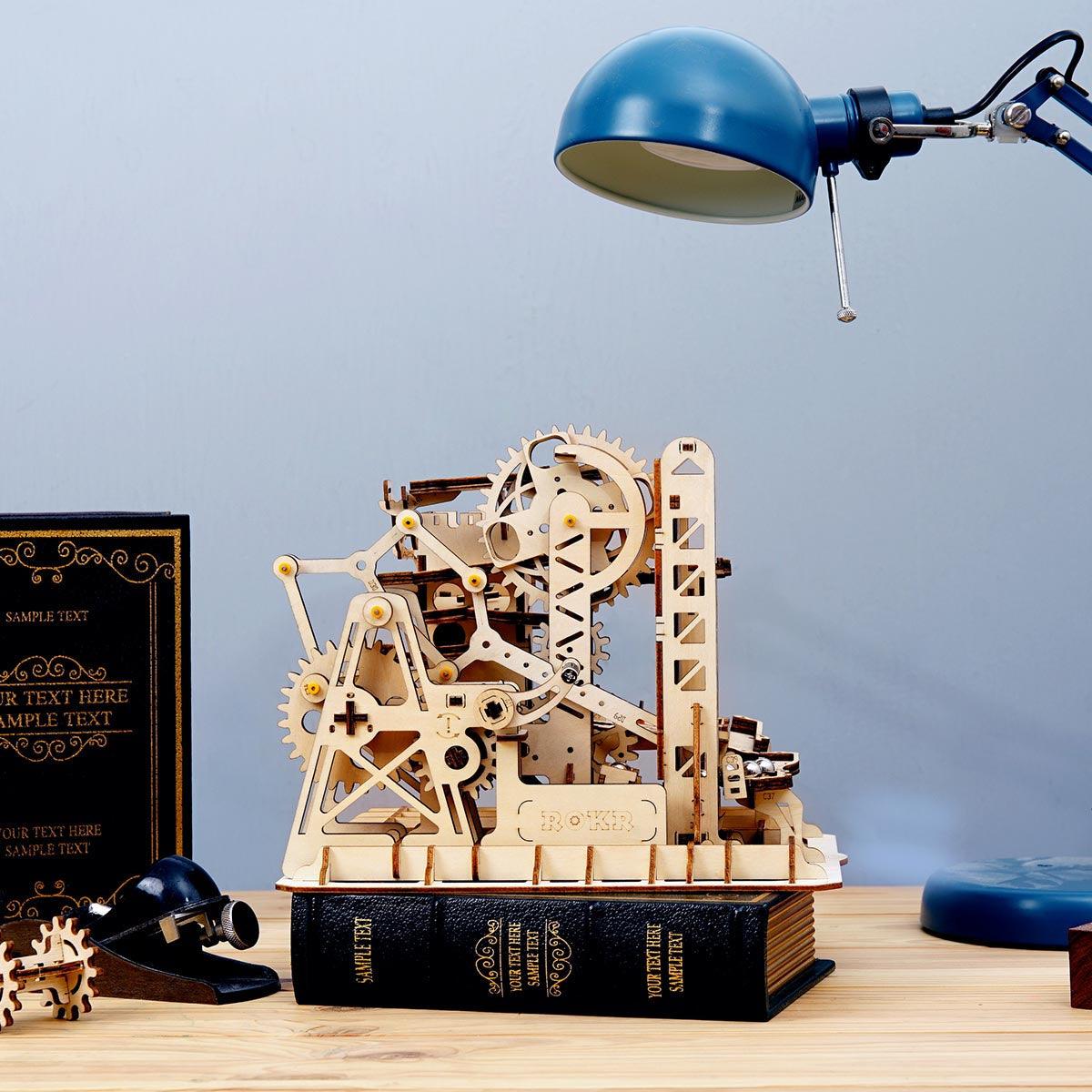 Trapdoor Tactician marble run with a trapdoor track, lift ladder and gears, a hands-on physics model kit for adults