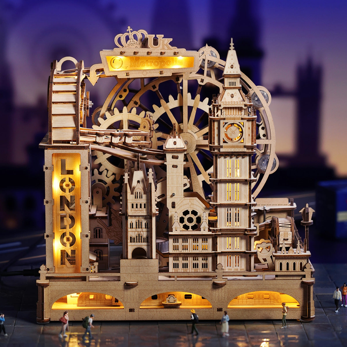 Wooden marble run kit with a motorized four track system that keeps metal marbles rolling for interactive play