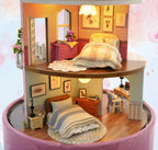Three furnished floors of a miniature dollhouse kit with a cozy bedroom and a mint green living room study for adults