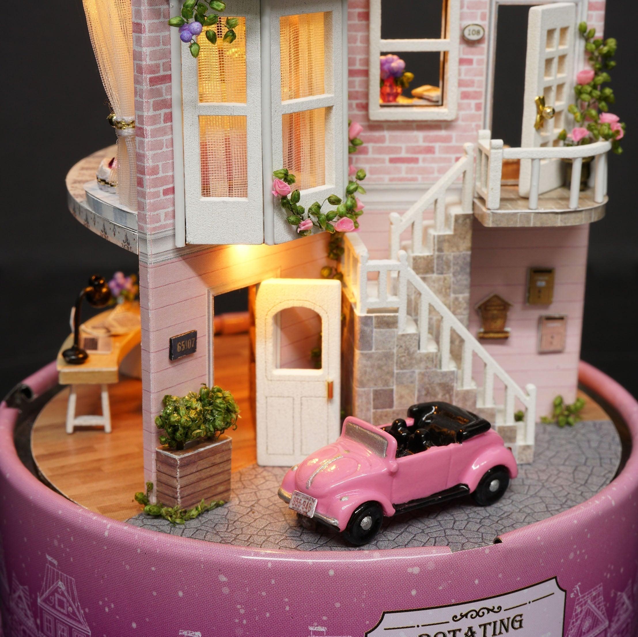 Pink brick townhouse facade miniature with a vintage car and white staircase for a handmade model building craft gift