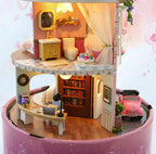 Miniature dollhouse kit interior with a book filled study desk and a bright bathroom for an adult 1:24 model build