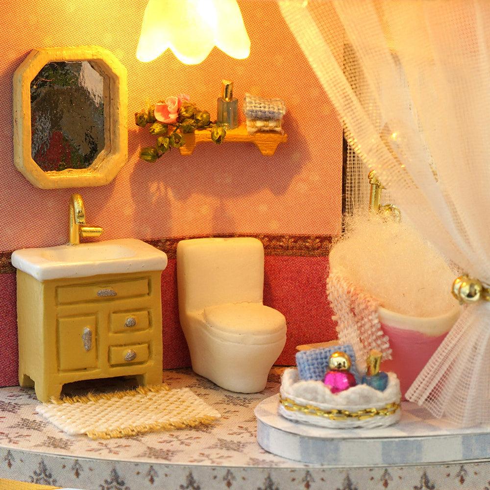 Bathroom vanity bathtub and toilet fittings inside a hands on miniature dollhouse kit and lit shelf display piece