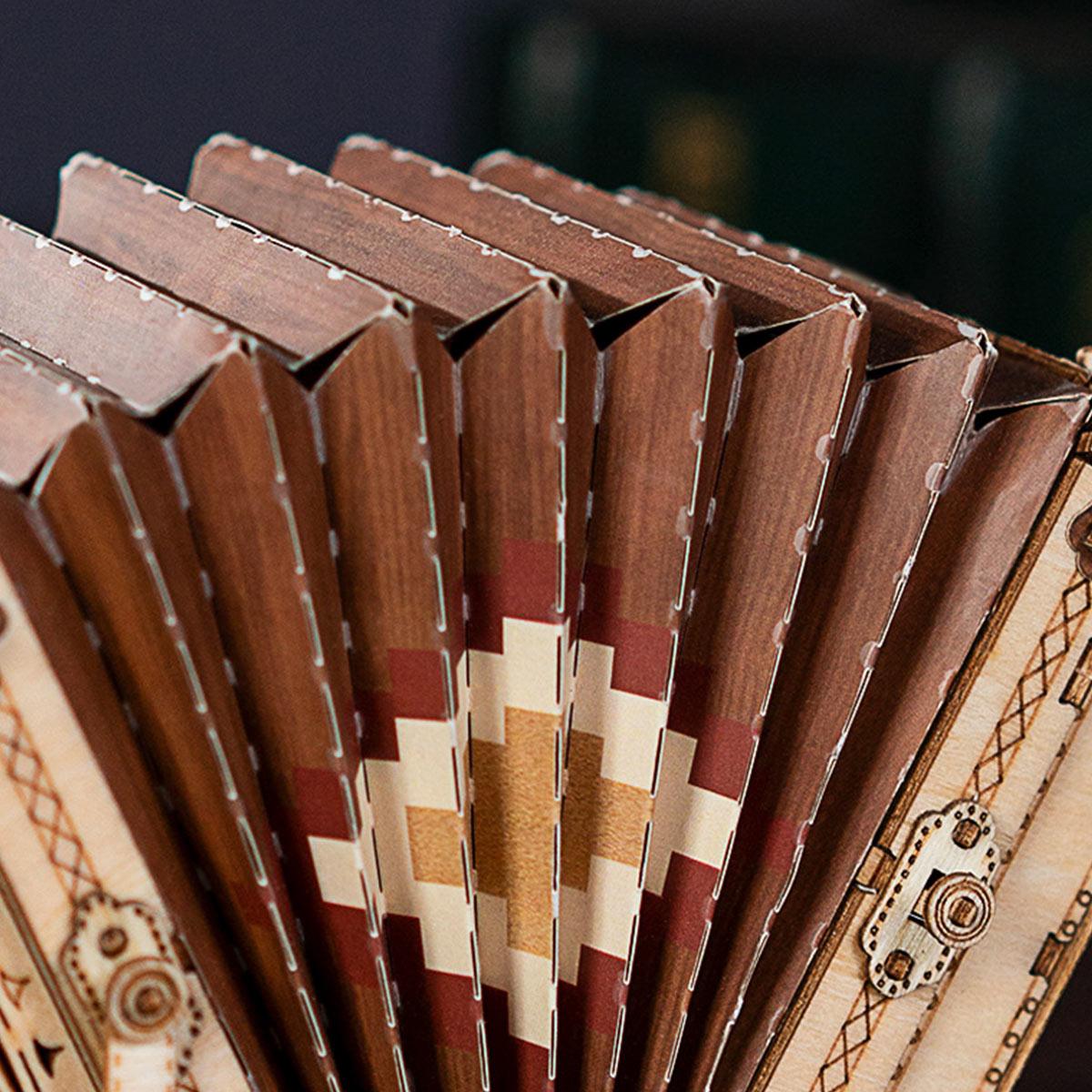 Ornate folded bellows and keyboard on an accordion model kit, a laser-cut wooden puzzle for adult hobbyists and collectors