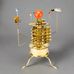 3D metal orrery solar system model kit with all eight planets orbiting a brass sun, a mechanical astronomy desk display