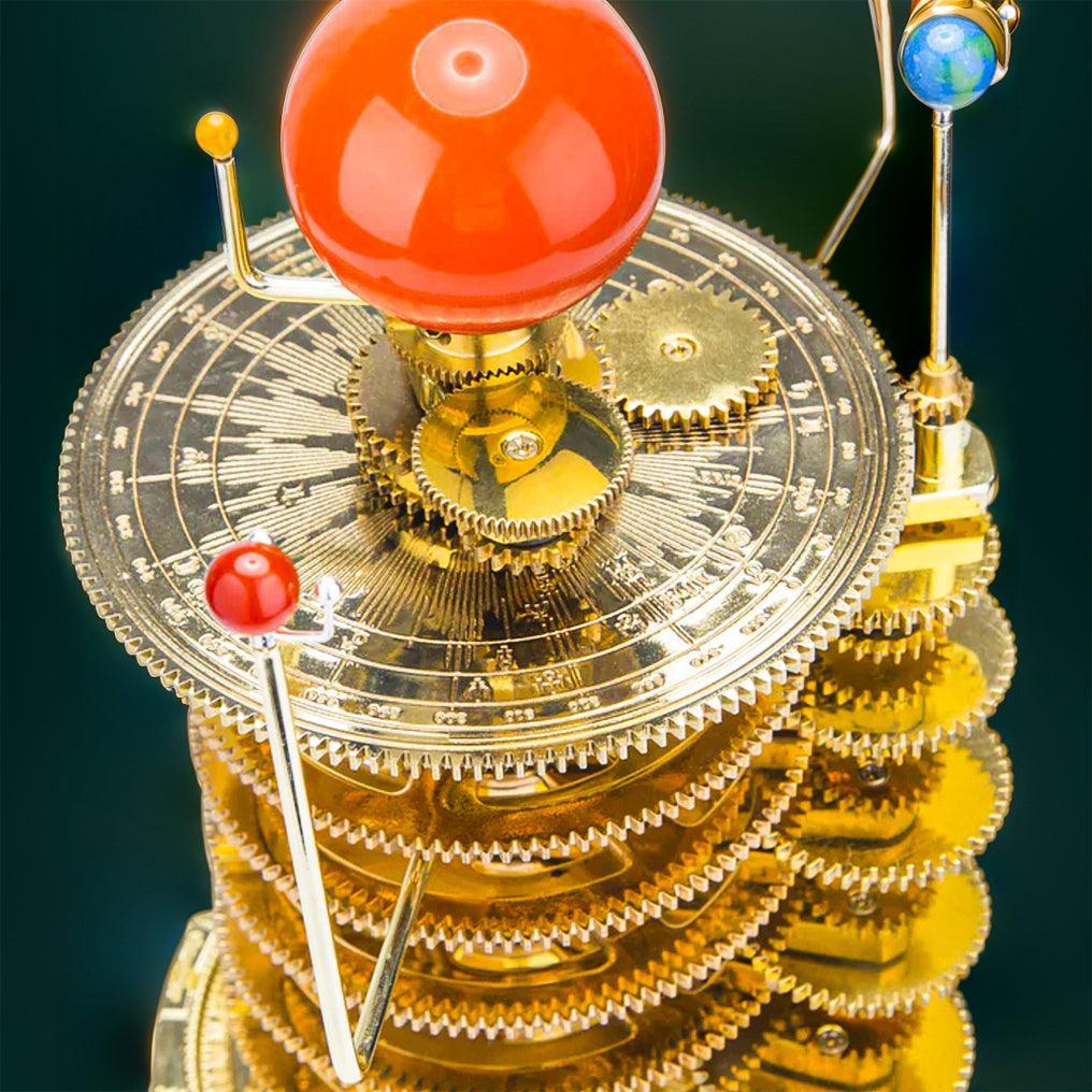 Working brass gears and orbital arms of a mechanical solar system model, an astronomy build kit for adults and collectors
