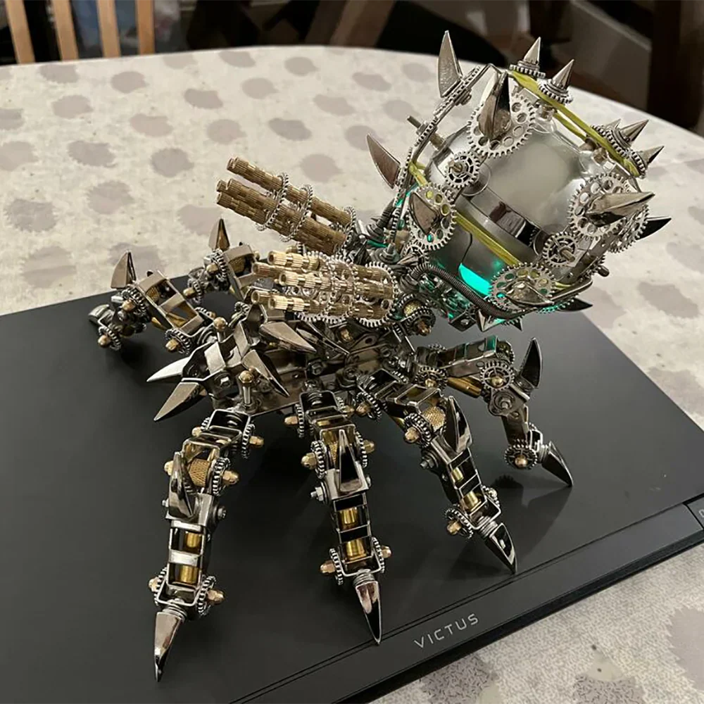 Metal tarantula speaker model displayed beside a laptop, an articulated arachnid sculpture and gift for adult builders Tarantula
