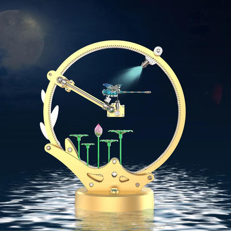 Movable metal Dragonfly kinetic model kit with a spotlight LED effect and lotus pond scene, motorized moving wings for hobbyists