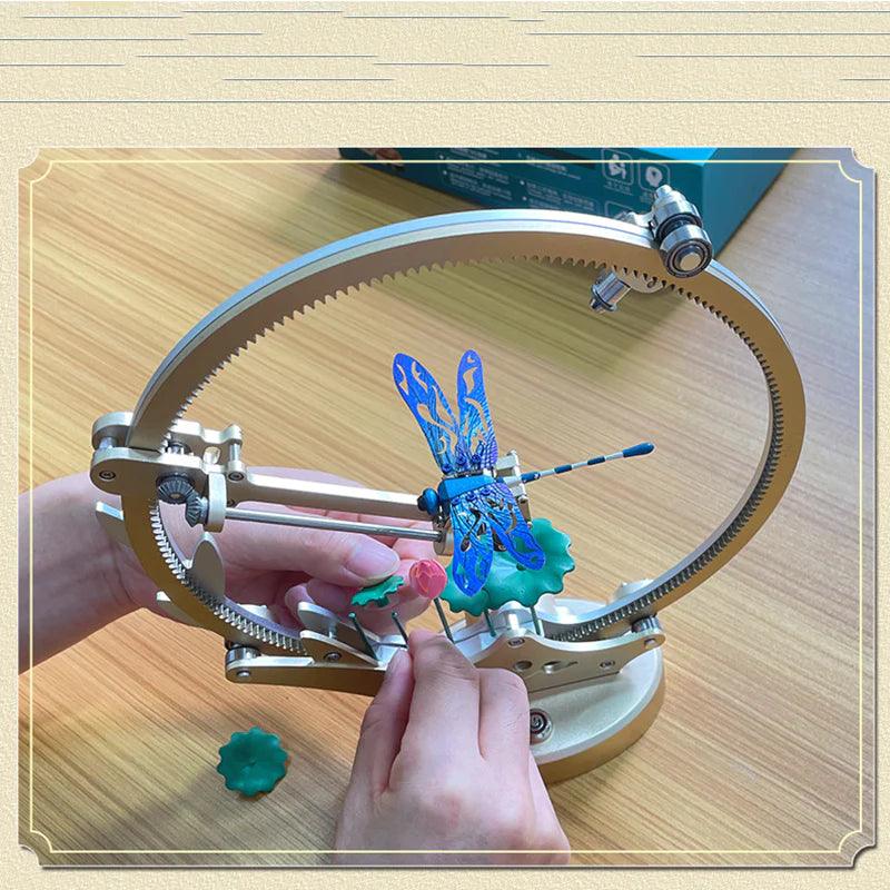 Assembling the Dragonfly metal model kit by hand, a 100 piece motorized puzzle project and hobby gift for adult builders