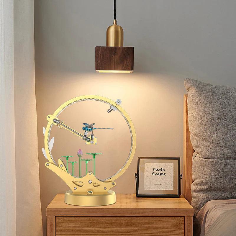 Dragonfly kinetic metal model on a bedroom nightstand, a motorized LED puzzle kit and decor gift for model collectors