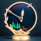 Santa Claus metal puzzle sculpture glowing on a dark desk, a motorized kinetic centerpiece and holiday display for adults