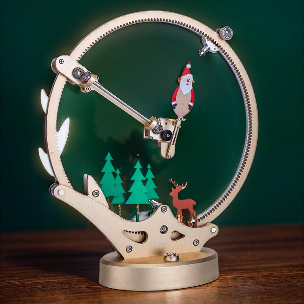 Santa Claus mechanical metal puzzle lit up on a wood desk, a motorized Christmas and birthday gift for kinetic art fans