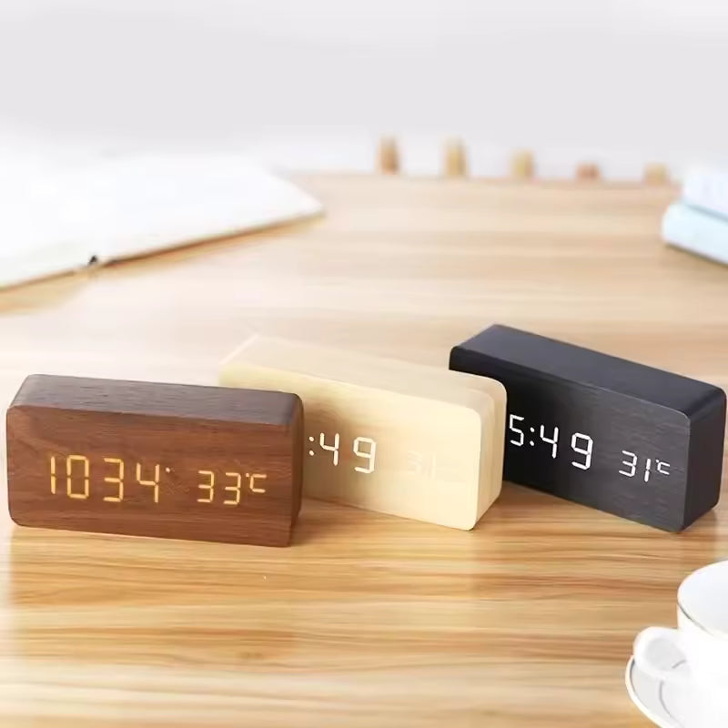 Black wood LED alarm clock shown with other natural wood tone finishes, a digital desk clock and thoughtful housewarming gift