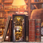 Space galaxy book nook kit that slots between books on a shelf with LED lighting for adult crafters and readers