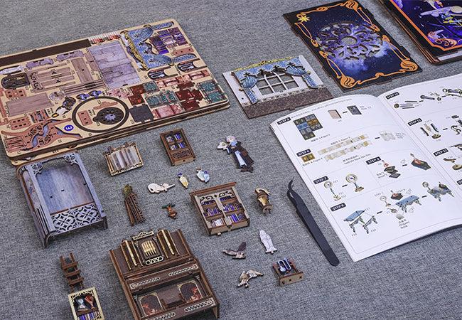 DIY book nook kit parts and color coded instructions laid out for a hands on space craft project for adult hobbyists