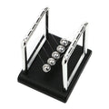 Steel ball pendulum on a black base pulled back to start a swing, a hands on physics demonstrator for desk or classroom (fits SKU_1748792312012_491)