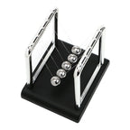 Steel ball pendulum on a black base pulled back to start a swing, a hands on physics demonstrator for desk or classroom (fits SKU_1748792312012_491)