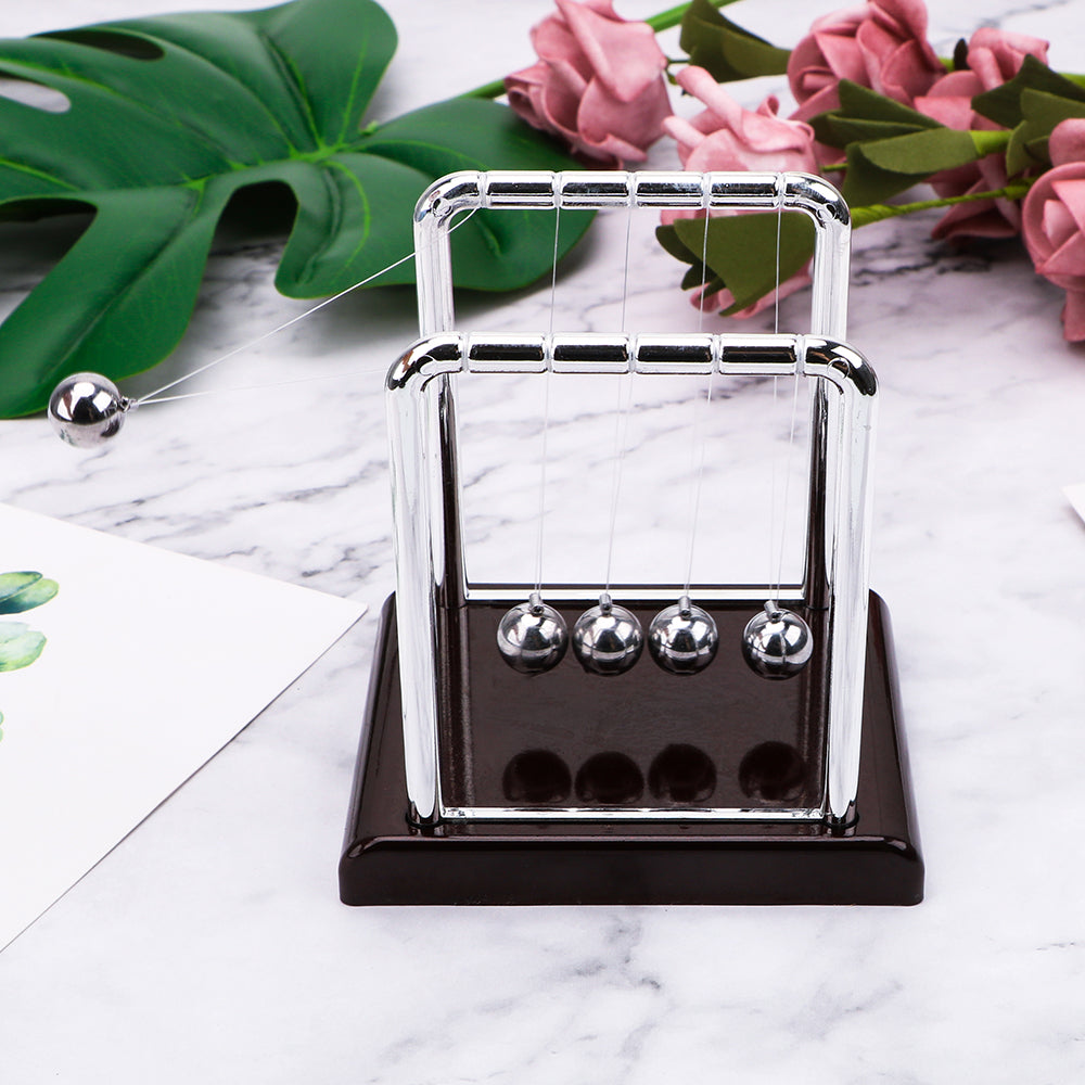 Newton's cradle with a red base styled on marble as an elegant science gift and reception desk decor piece for an office (fits SKU_1748792312012_64)