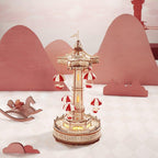 Glowing wooden music box that plays a melody, a rising parachute ride model and centerpiece for music box collectors