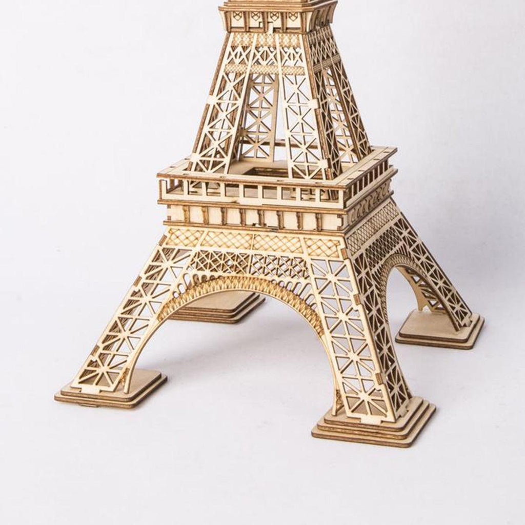 Eiffel Tower model kit with detailed wooden latticework arches, an easy no glue build for architecture and Paris enthusiasts