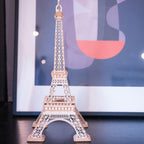 Assembled Eiffel Tower model styled as Paris themed home decor, a wooden architecture puzzle and display piece for any room