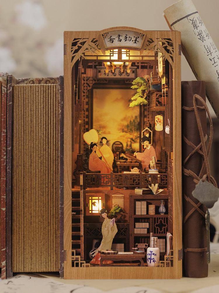 Classical Chinese study book nook lit between real books with hanging scroll art, lanterns, and antique shelves