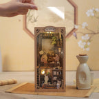 Chinese study book nook kit with a clear dust cover keeping the lamplit scholar diorama clean on a shelf