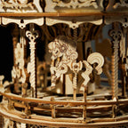 Carved wooden horses inside the merry go round that spin to the melody, a hands on mechanical model kit for teens and adults