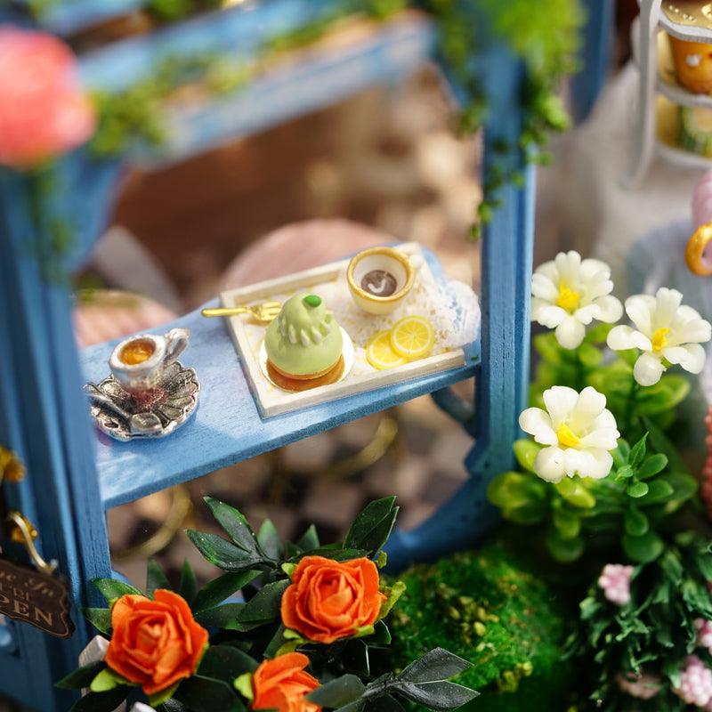 Miniature tea house dessert tray with tiny matcha cakes, lemon slices, and roses, a handmade patisserie craft detail
