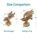 Two wooden airship model kits shown to scale, the Sailing In Fog steampunk blimp and a layered pavilion Sky Voyager
